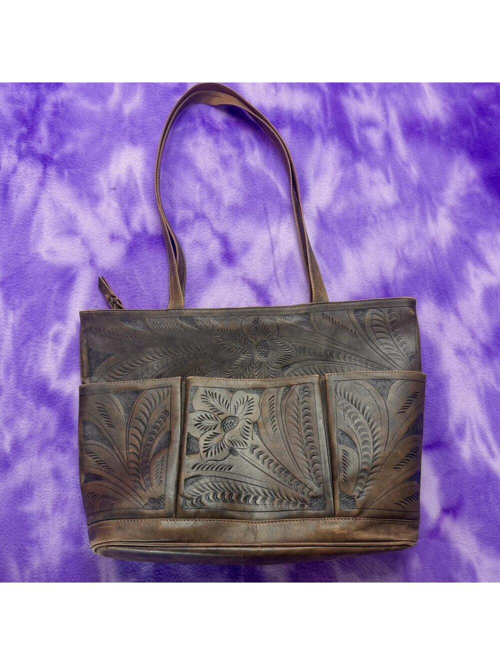 Leaders in leather hand tooled brown leather tote with pockets